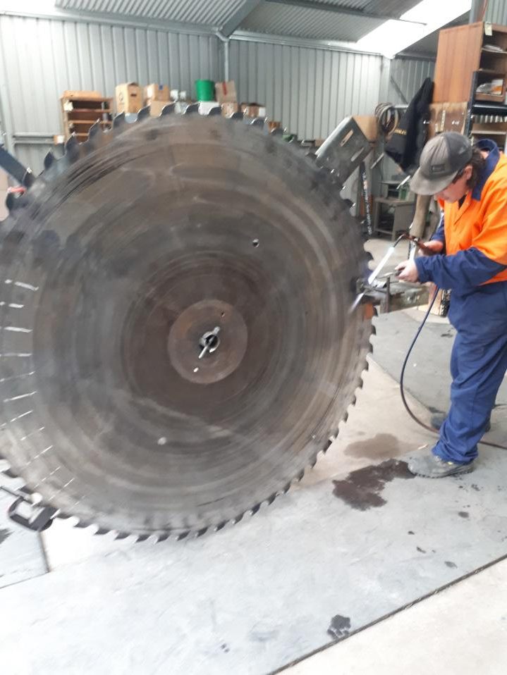 Large saw blade being sharpened and serviced by Huon Saw Service - Hobart and Southern Tasmania